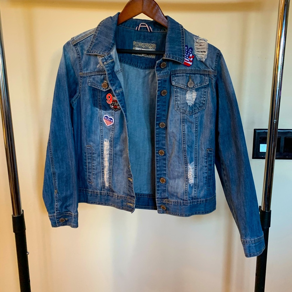 Distressed denim jacket with patches